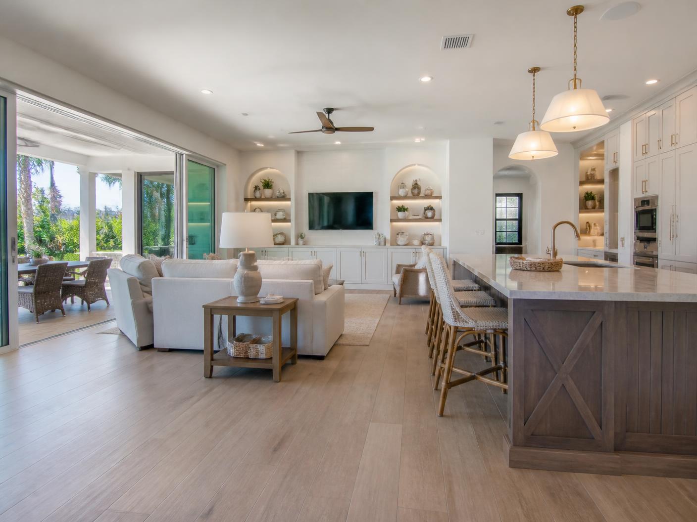 Remodeling project manager measuring a gutted Boca Raton living room during a whole-home renovation